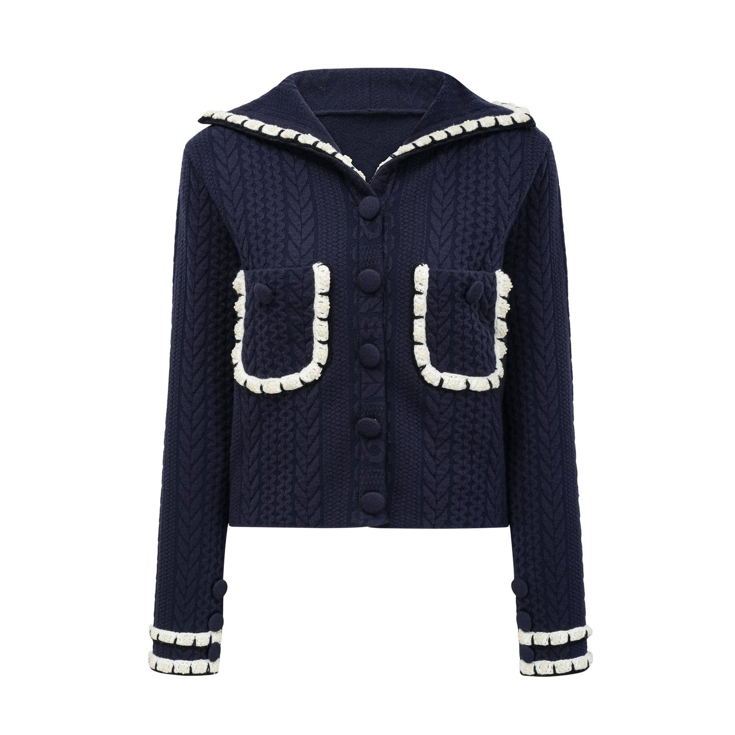 Woman wearing navy blue crochet knit cardigan and matching trousers standing in relaxed pose