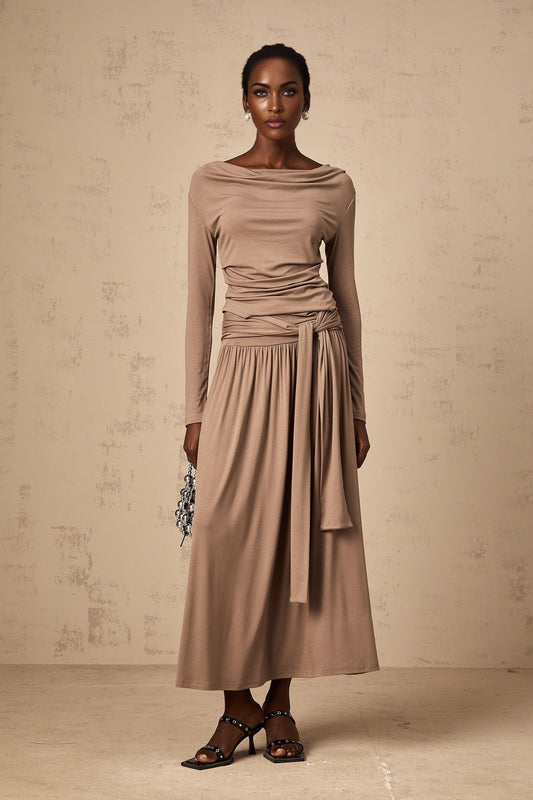Woman wearing oatmeal colored matching set with draped top and skirt made of stretchy fabric