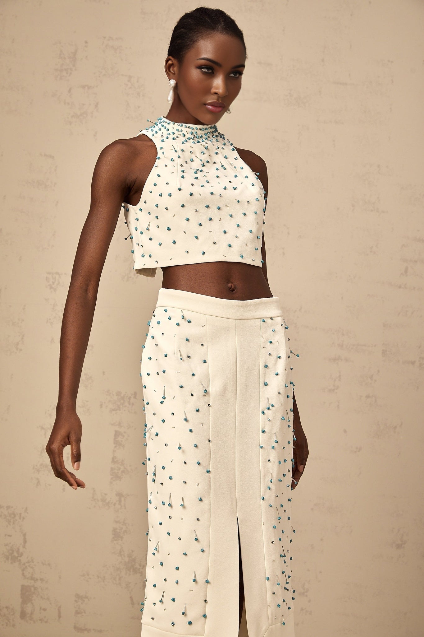 Woman wearing offwhite matching set with embellished top and skirt