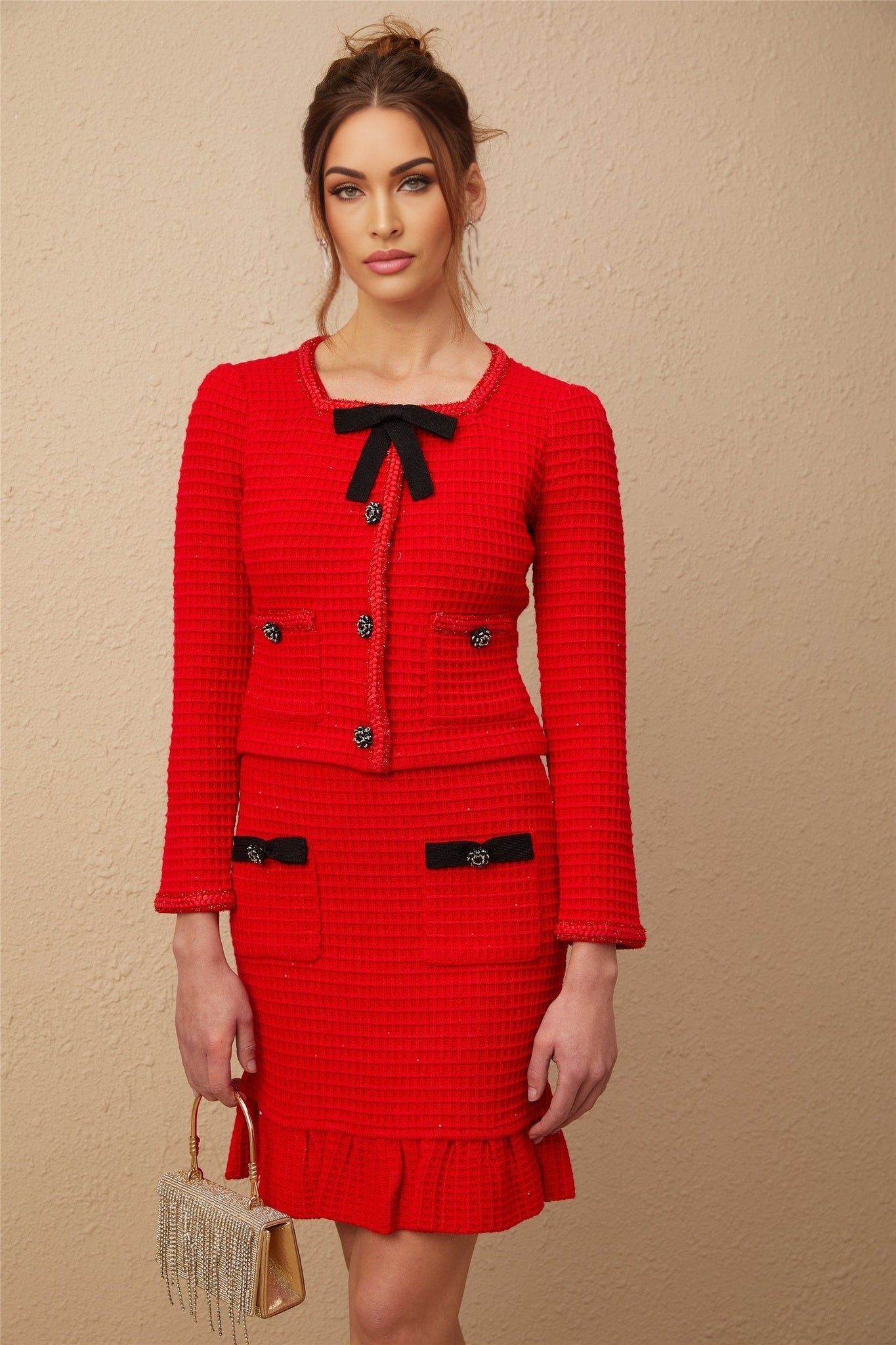 Woman wearing red braided waffle knit jacket and matching skirt set Cynthia style outfit