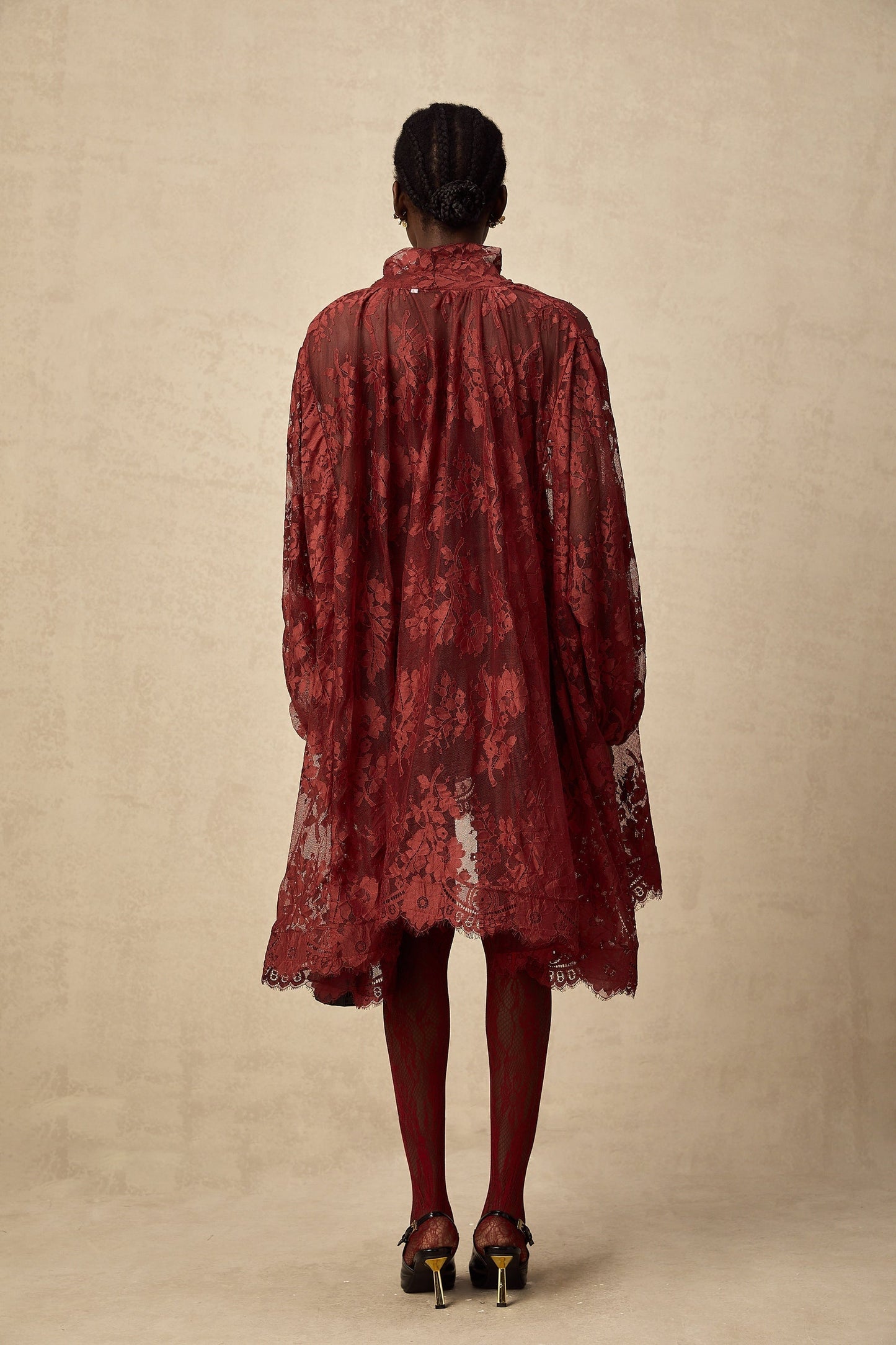 Woman wearing red floral lace tights with cutout pattern on legs