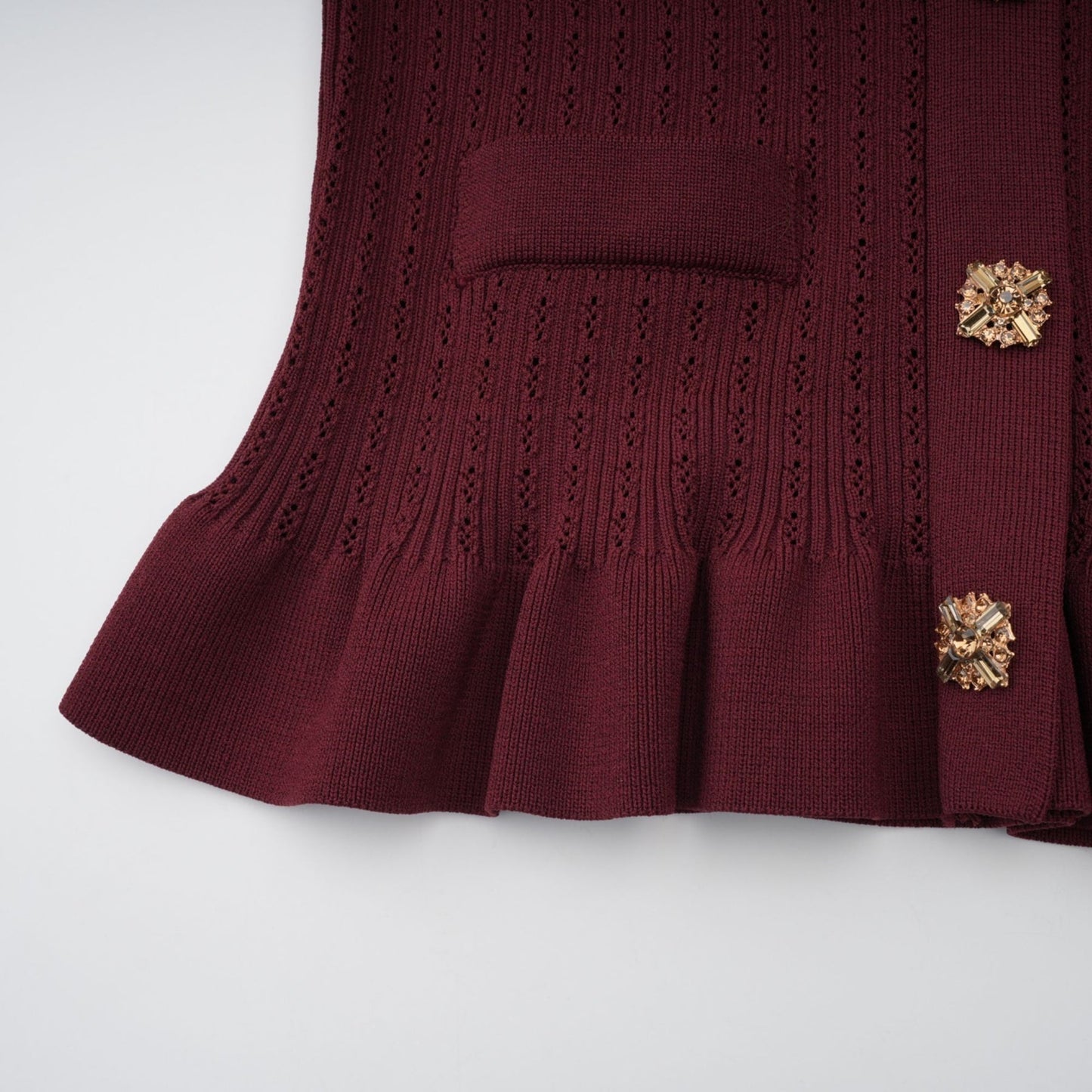 Woman wearing red knit matching set with ruffled top and skirt called Corrine