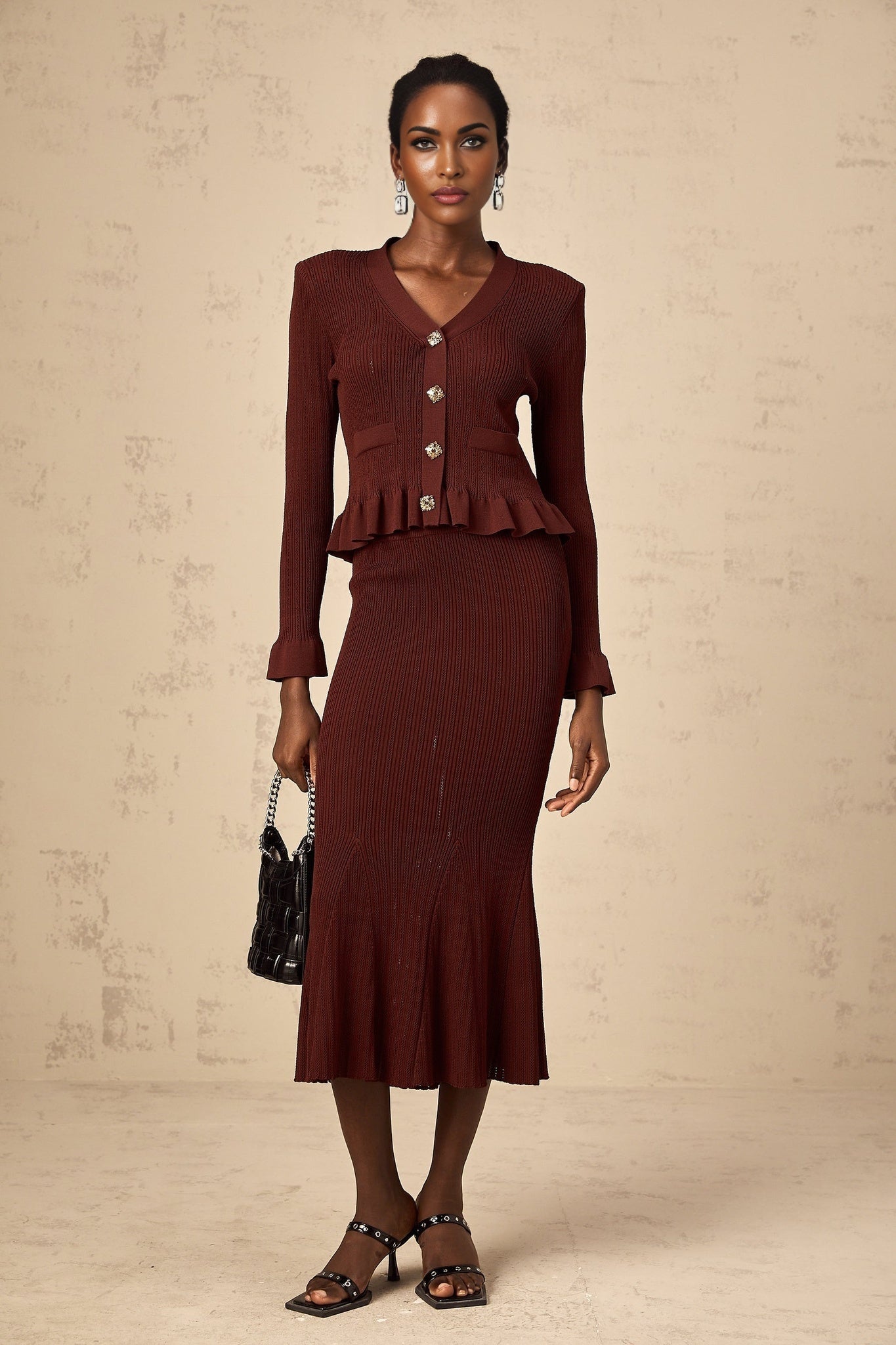 Woman wearing red knit matching set with ruffled top and skirt named Corrine