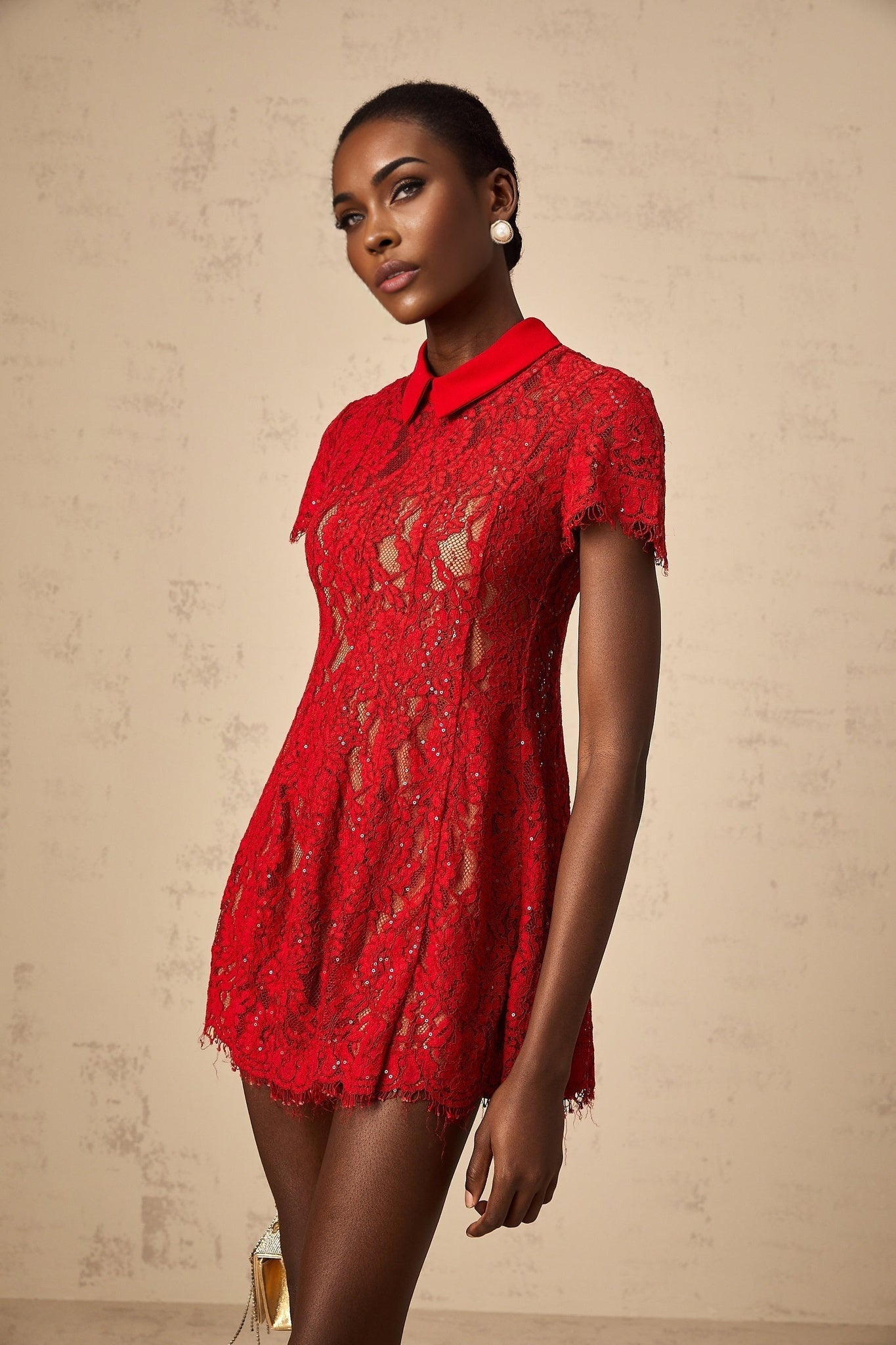 Woman wearing red mini dress with sequined lace detail