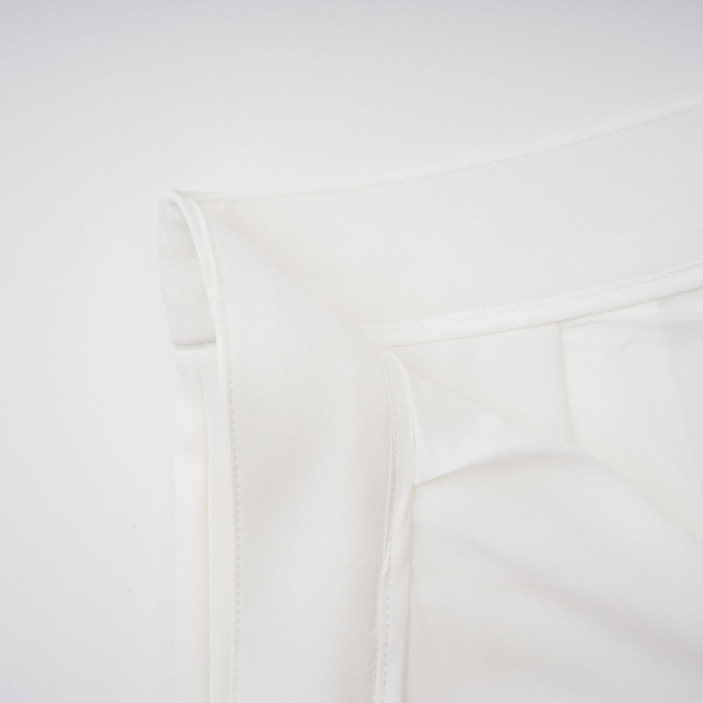 Woman wearing white creased top and matching trousers set