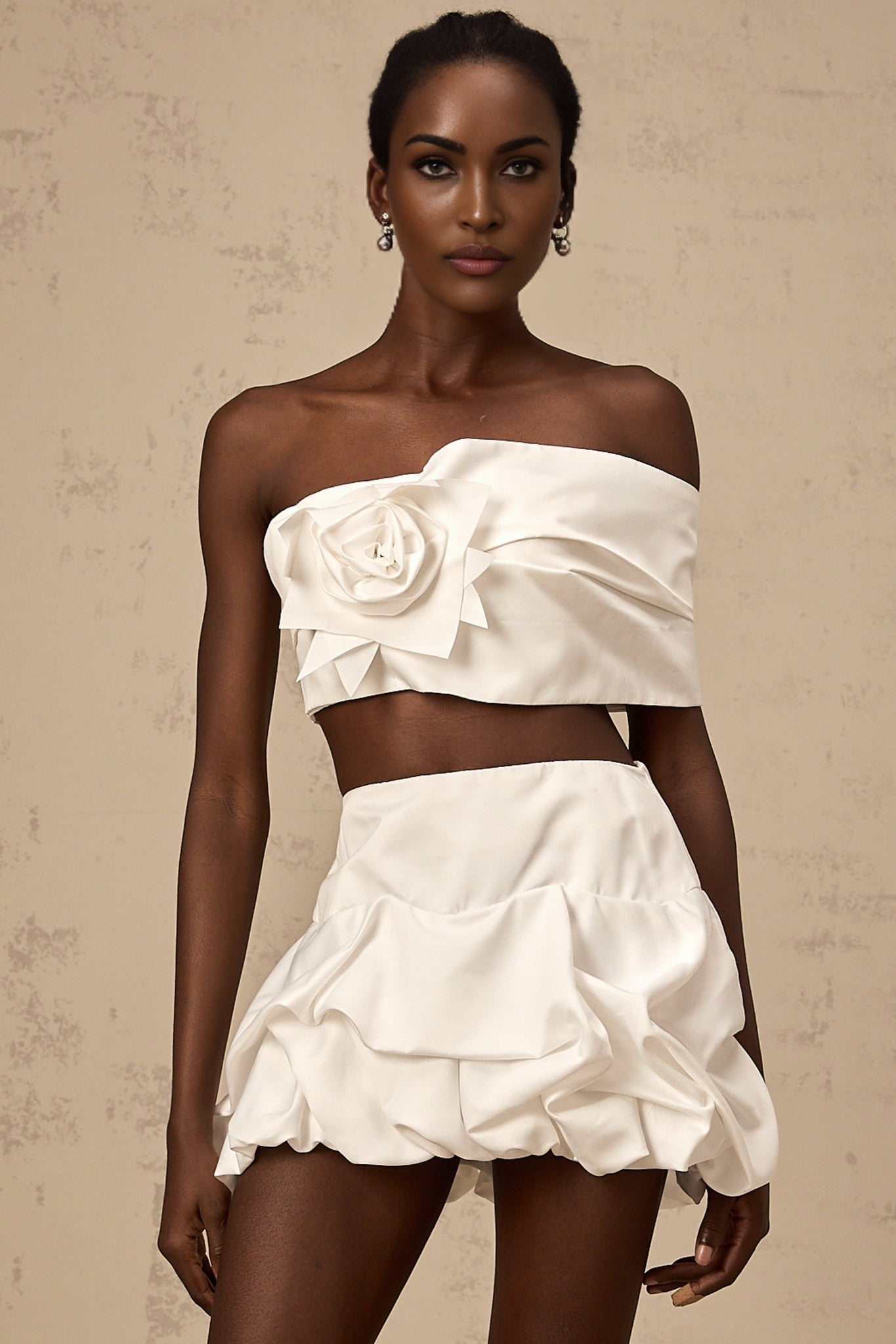 Woman wearing white floral print top and matching skirt set Pleated design visible on both pieces