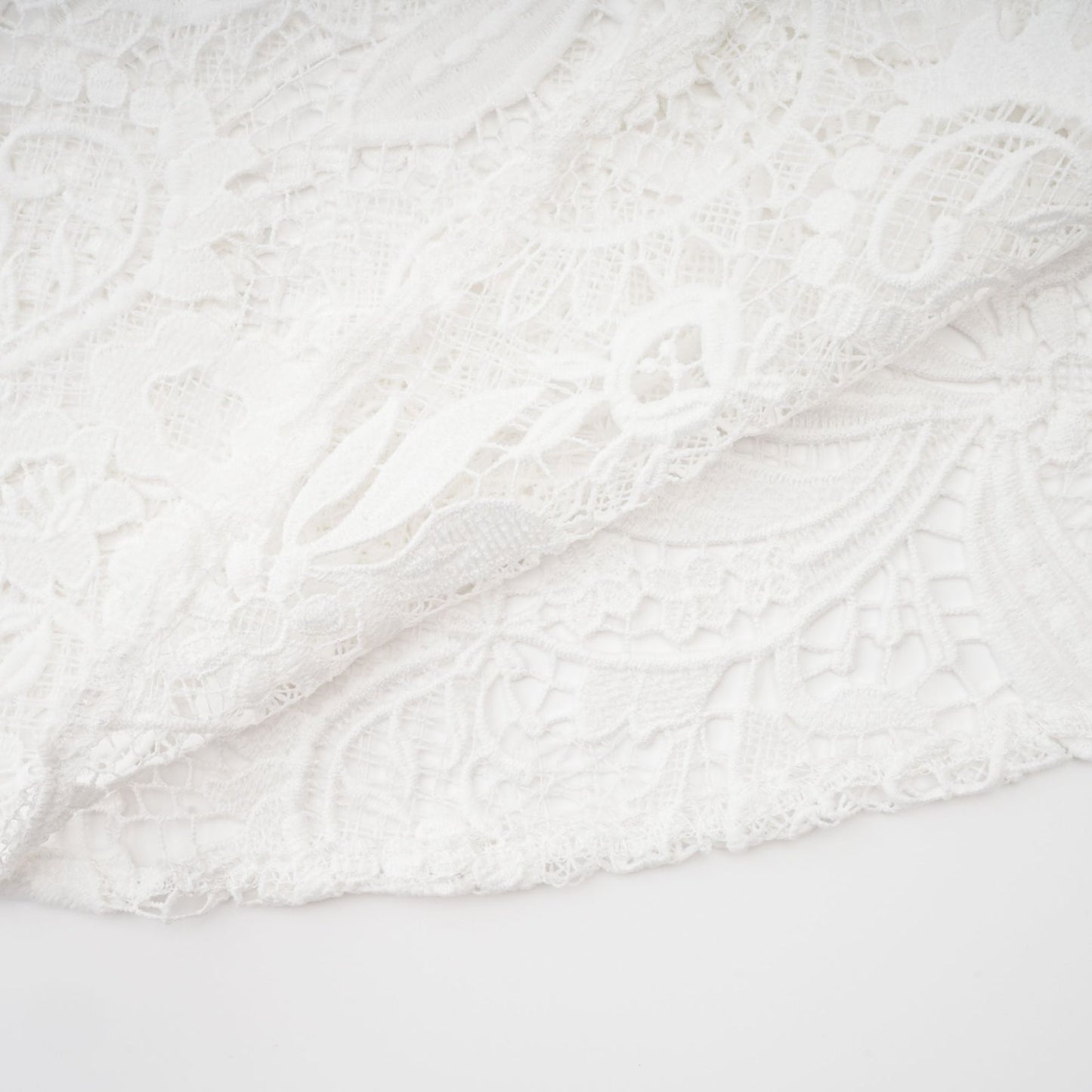 White Aline dress with crew neck long sleeves embroidered lace detail cutout design and cinched waist Hem features a flounce mini length front button closure Made of 70% cotton 20% terylene 10% viscose