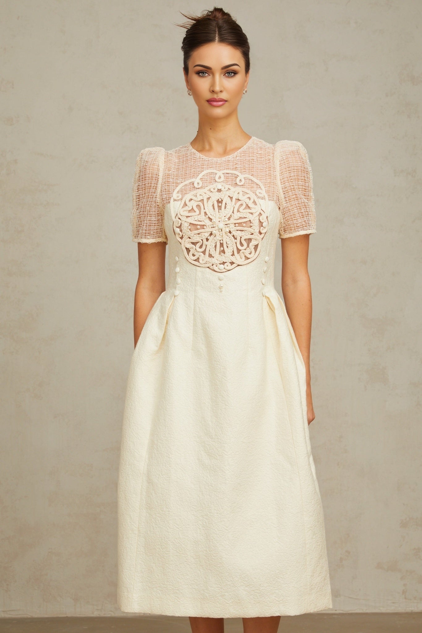 Woman wearing white midi dress with braided panelling and sleeveless design