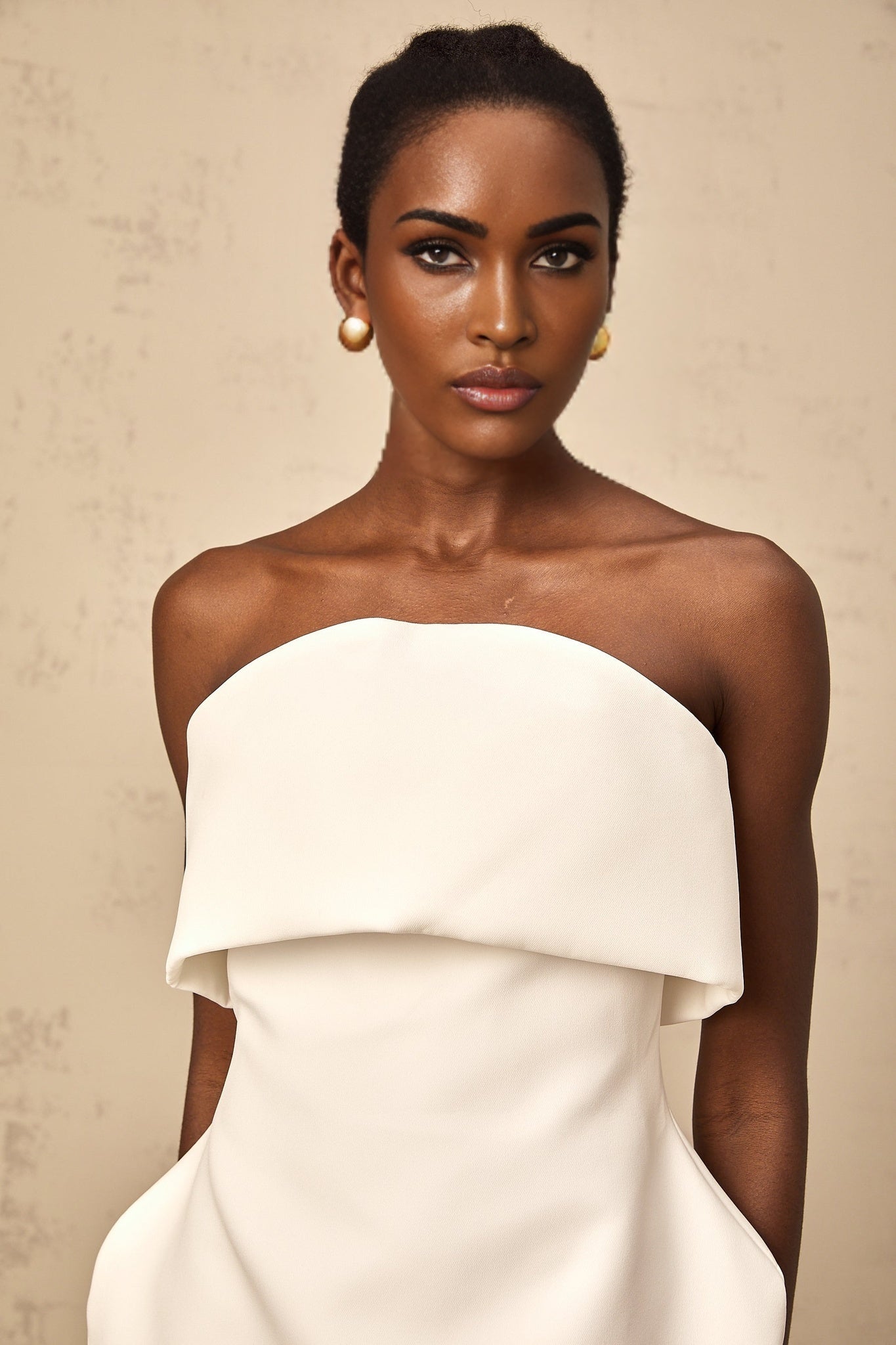 Woman wearing white off shoulder mini dress with puff sleeves