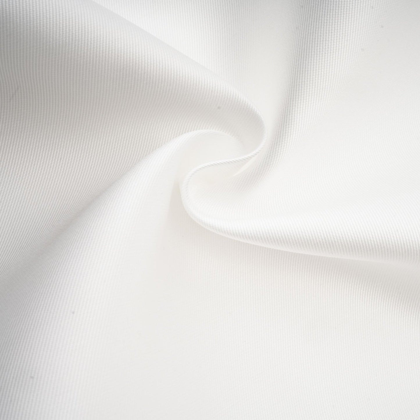Woman wearing white offshoulder maxi dress with panelled design standing against plain background