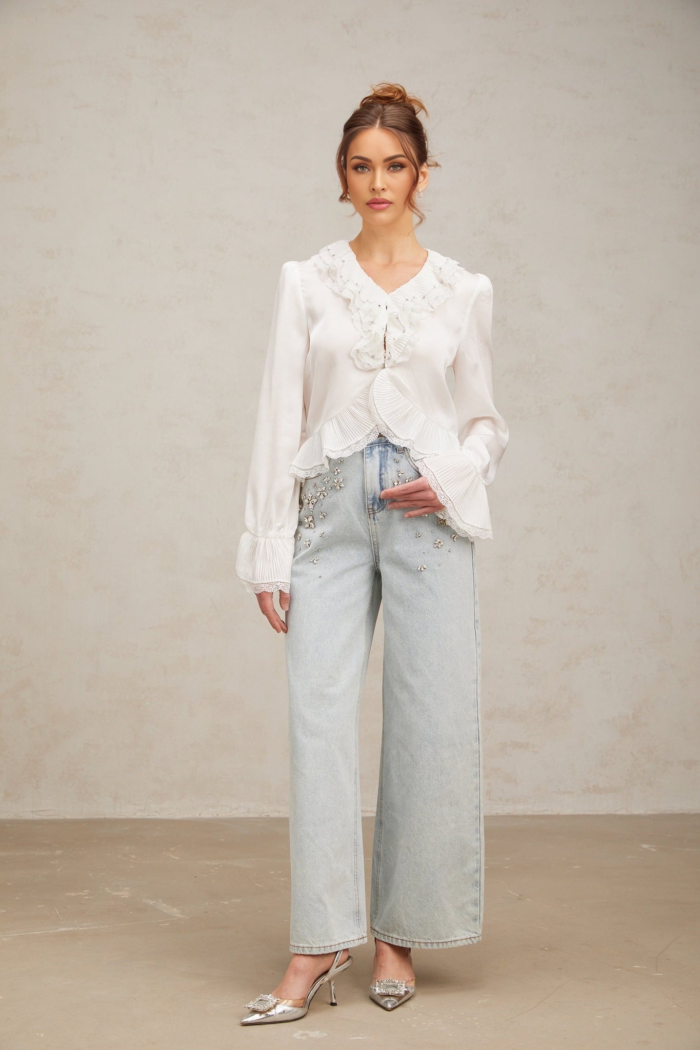 Woman wearing white shirt with lace trim and ruffled details