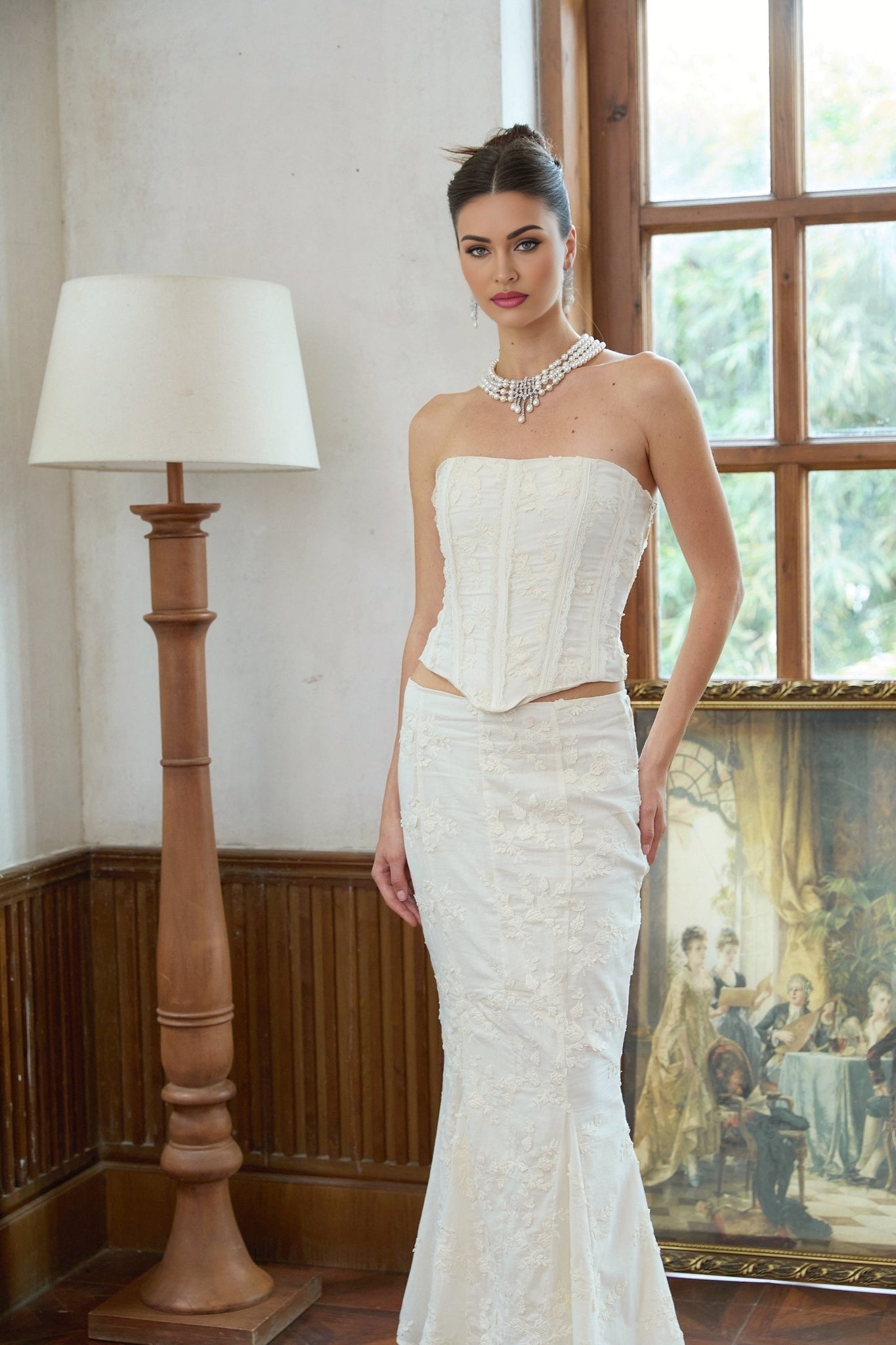 Woman wearing white twopiece outfit featuring embroidered top and matching skirt called Margot set