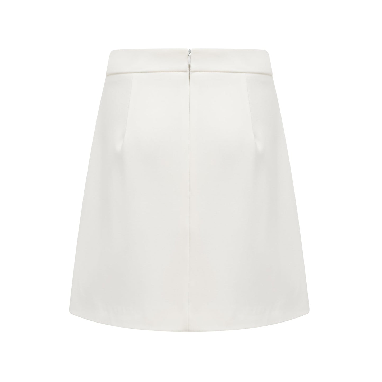 Woman wearing white twopiece outfit with crystal embellishments consisting of a sleeveless top and matching skirt