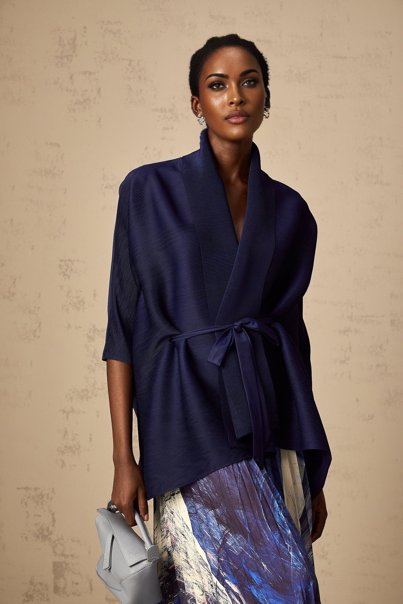 Womens matching outfit set featuring a blue patterned cape and skirt with a crinkled texture