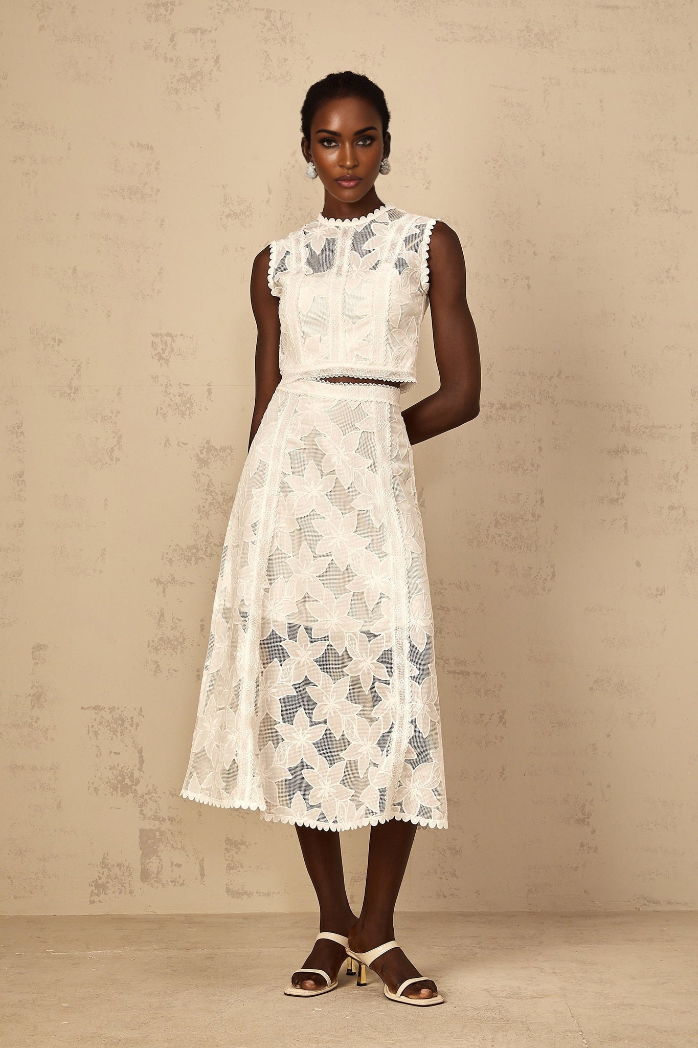 Womens white two piece set featuring floral embroidered top and matching skirt