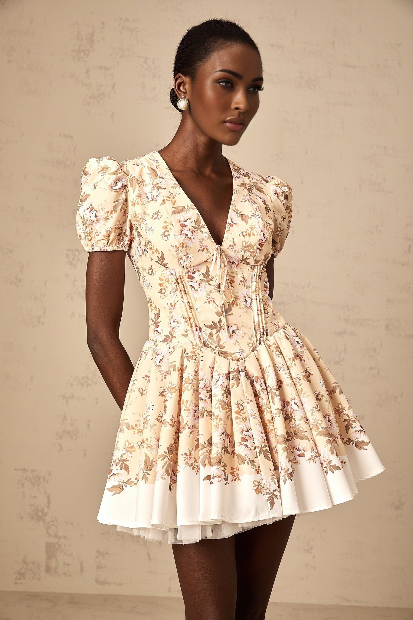 Yellow floral print mini dress with pleated design and short skirt named Alizee
