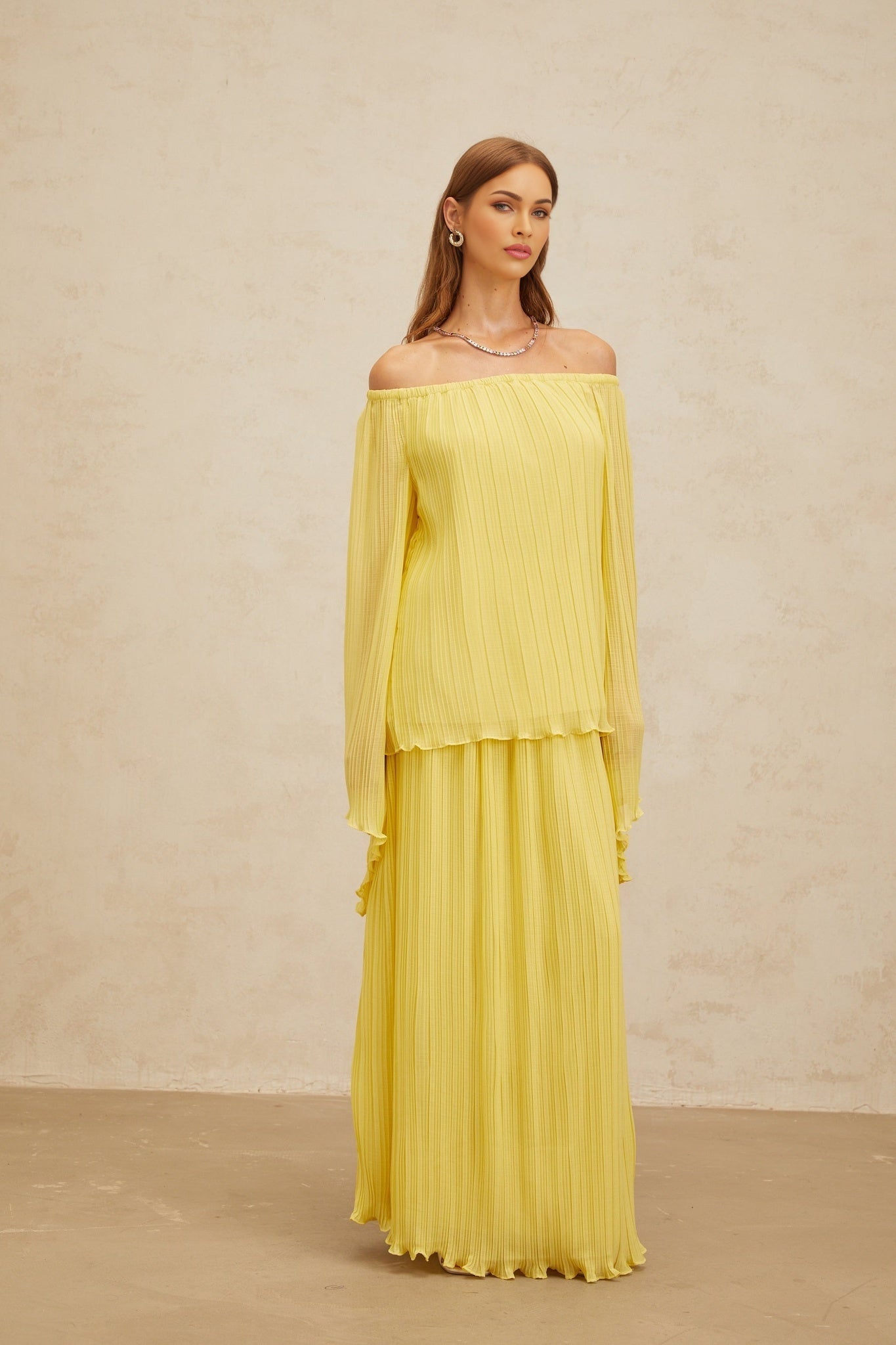Yellow off the shoulder blouse and maxi skirt set with ruffled hem and pleats made of 100% Terylene fiber