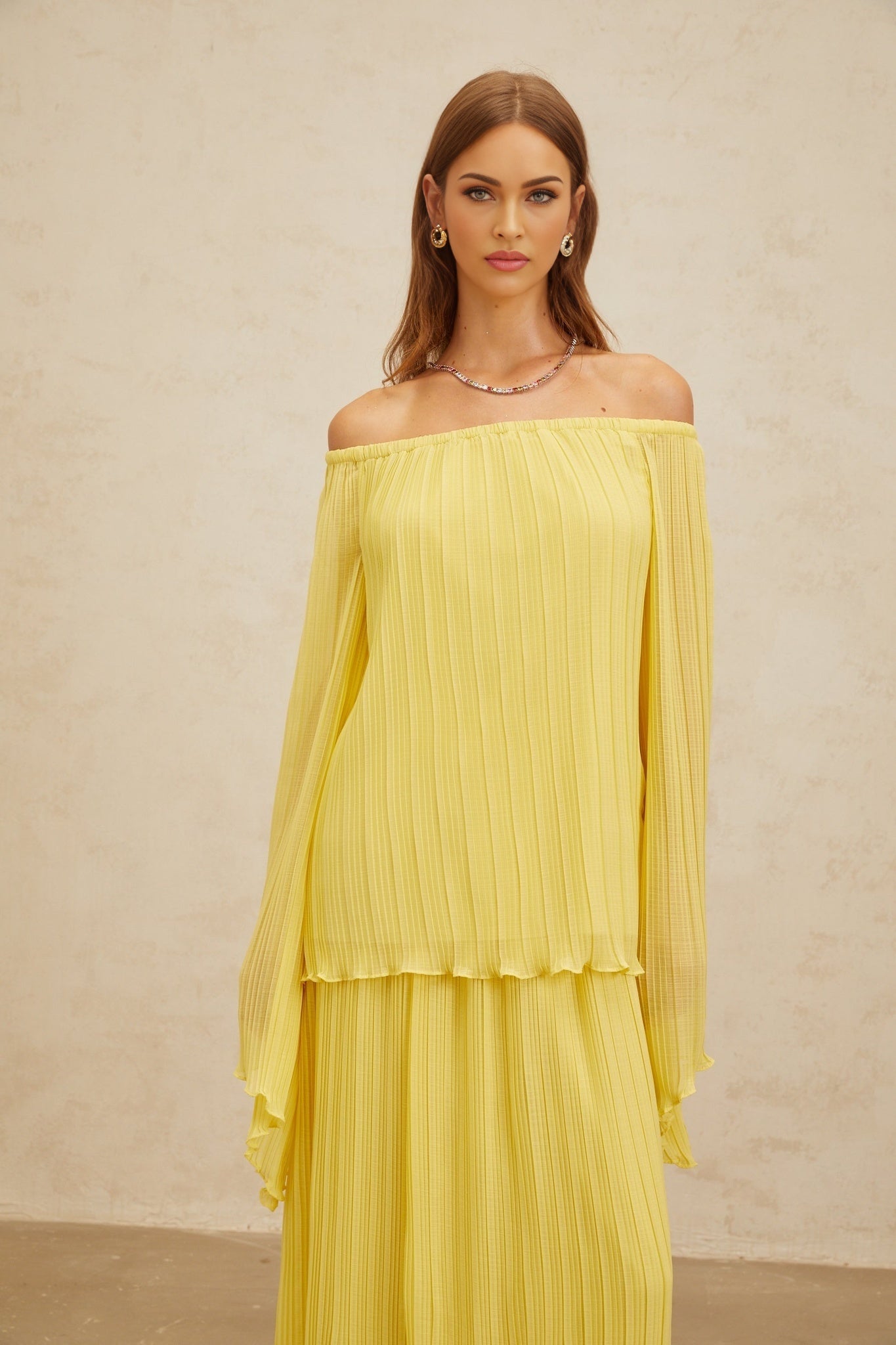 Yellow off the shoulder blouse and skirt set with ruffled hem and pleats made of 100% Terylene fiber