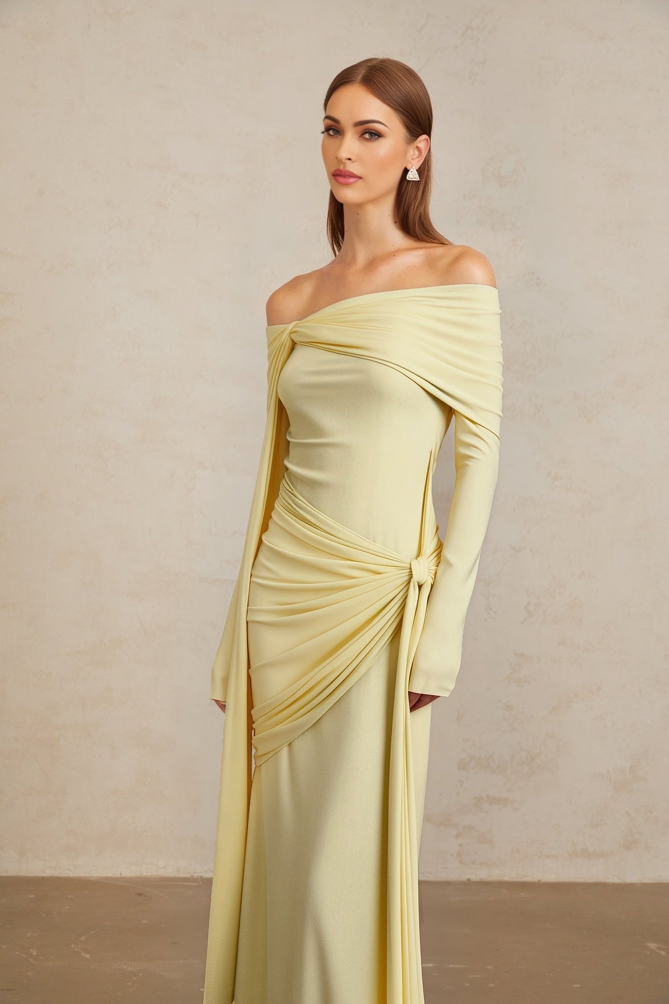 Yellow off the shoulder long sleeve dress with front tie detail and pleated, asymmetrical, ruched, and draped detailing