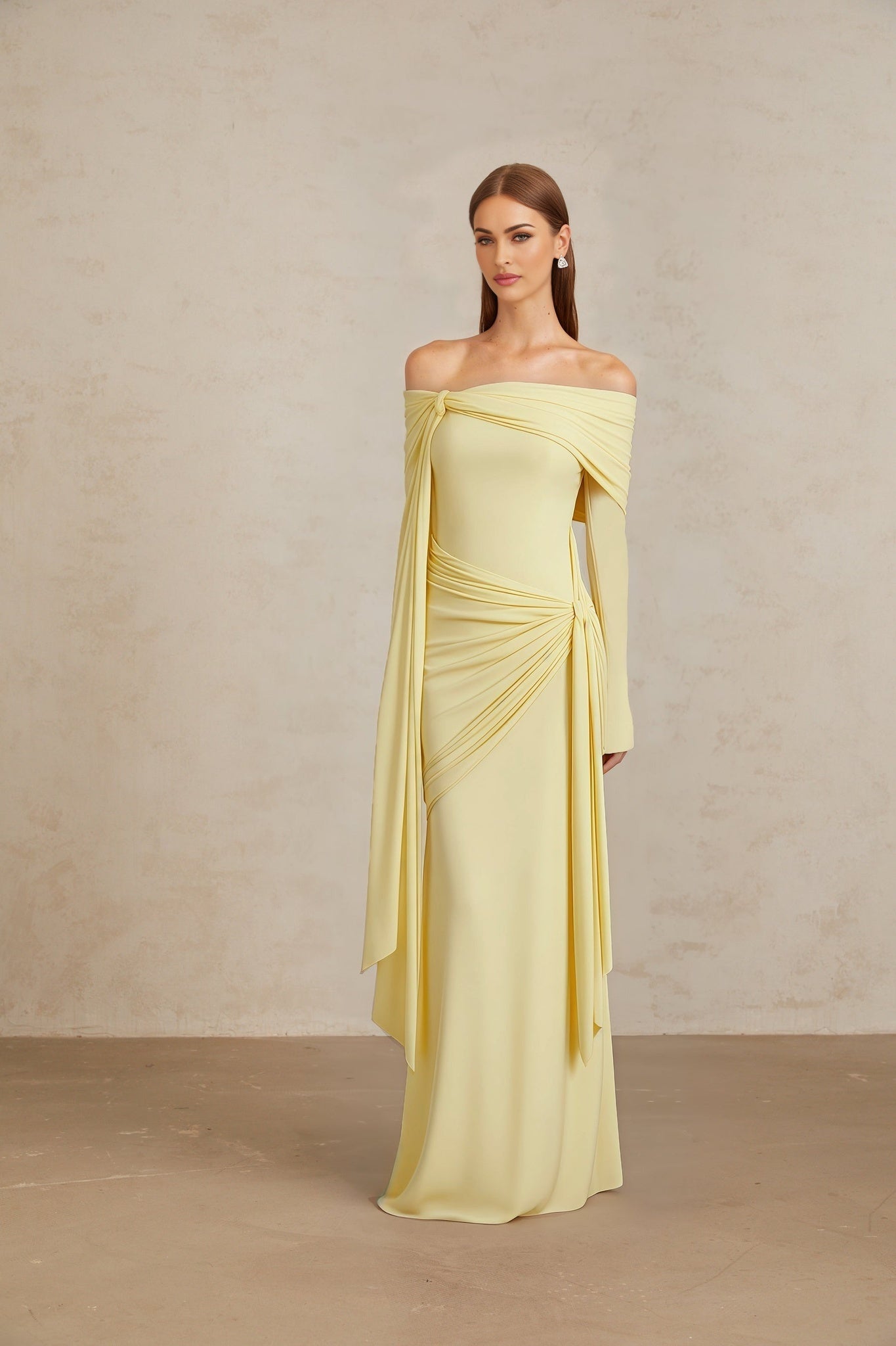 Yellow off the shoulder long sleeve dress with front tie detail, pleated detailing, and asymmetrical design