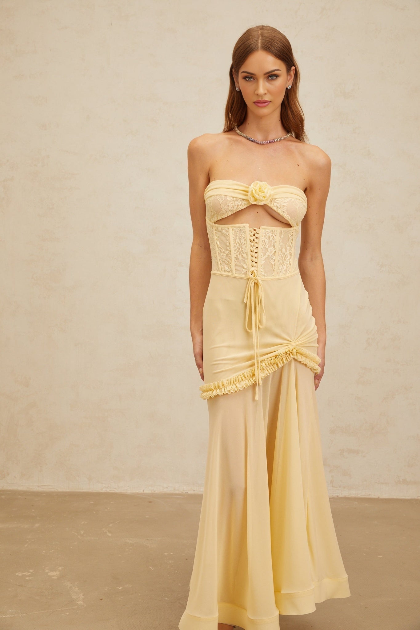Yellow sleeveless off the shoulder corset style dress with 3D-petal detailing, floral lace panelling, and ruffled trim