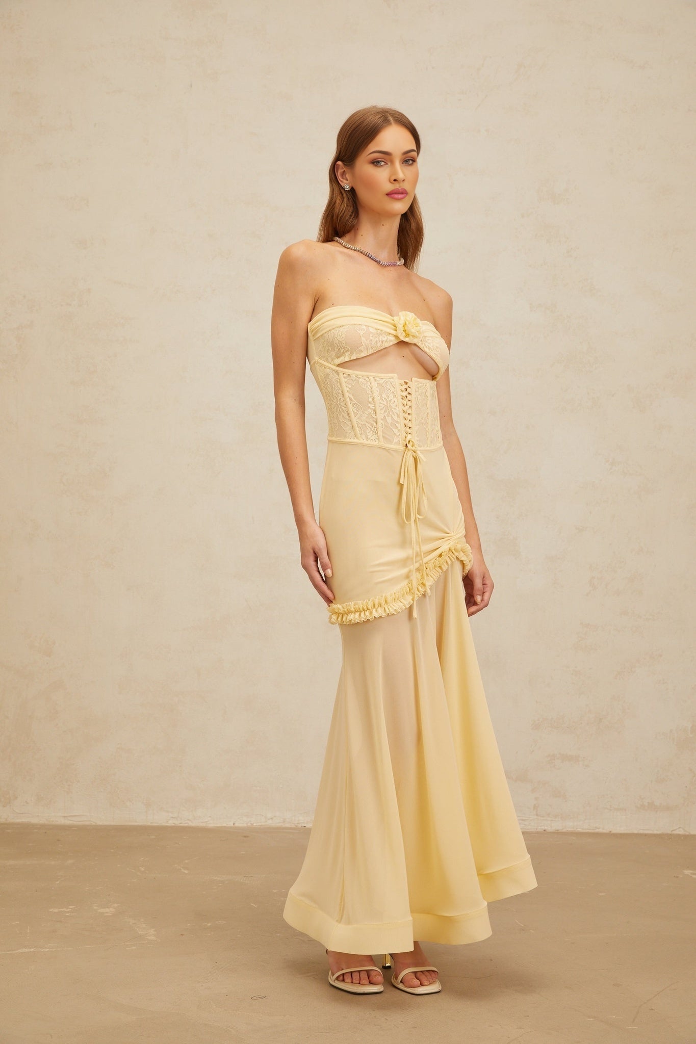 Yellow sleeveless off the shoulder corset style dress with 3D-petal detailing and floral lace panelling