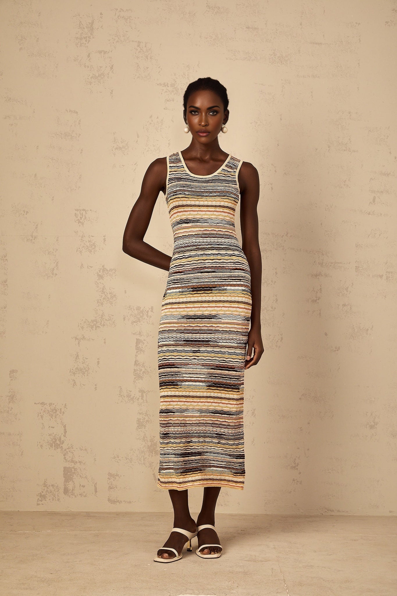 Yellow striped crochet knit midi dress with a fitted silhouette and sleeveless design called Quentin