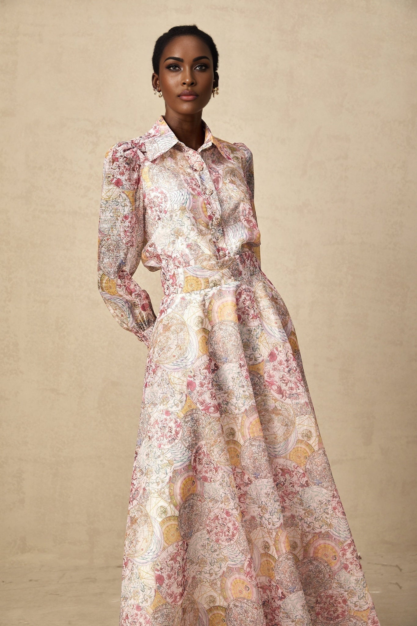 Young girl wearing a cherry pink shirt and skirt set with allover pattern print