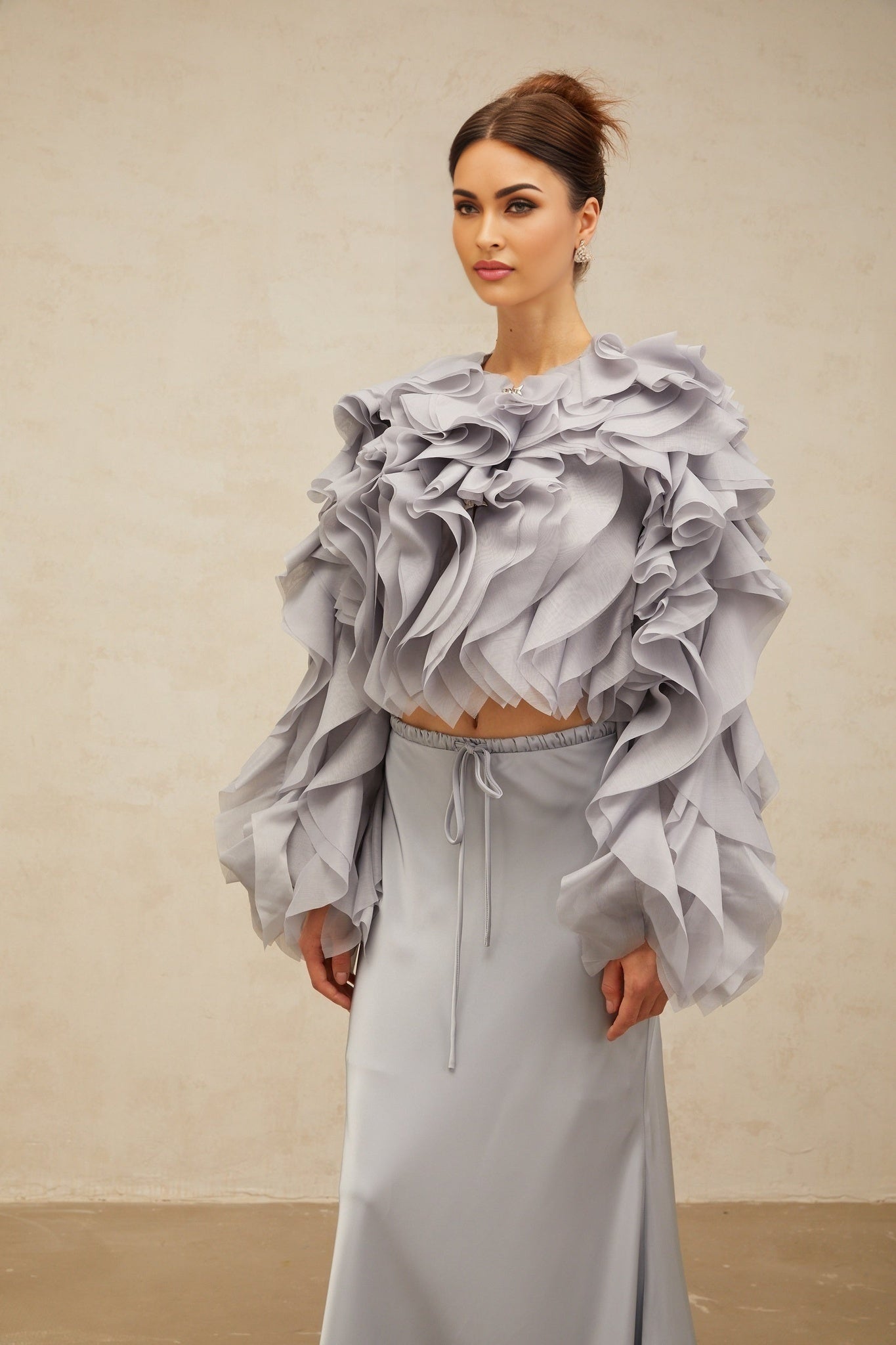 Young girl wearing a haze blue matching outfit consisting of a bowknot blouse with ruffles and a coordinating skirt named Zelda