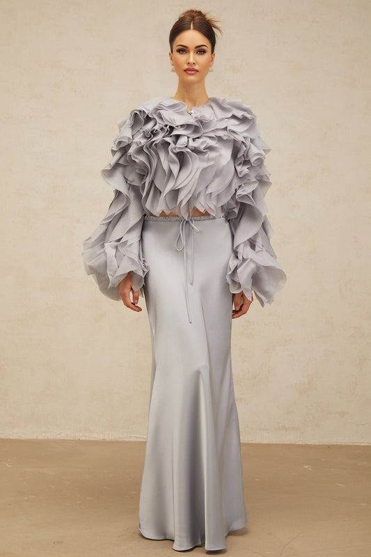 Young girl wearing a haze blue matching set with a ruffled blouse and skirt featuring a bowknot detail inspired by Zelda character design