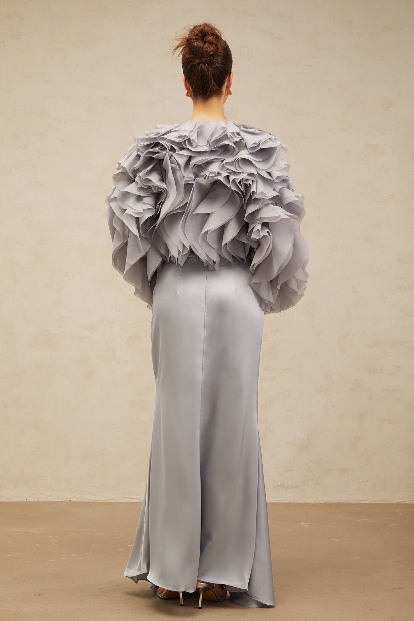 Young girl wearing a light blue matching outfit with a ruffled blouse and skirt featuring a decorative bow accent in a Zelda inspired design