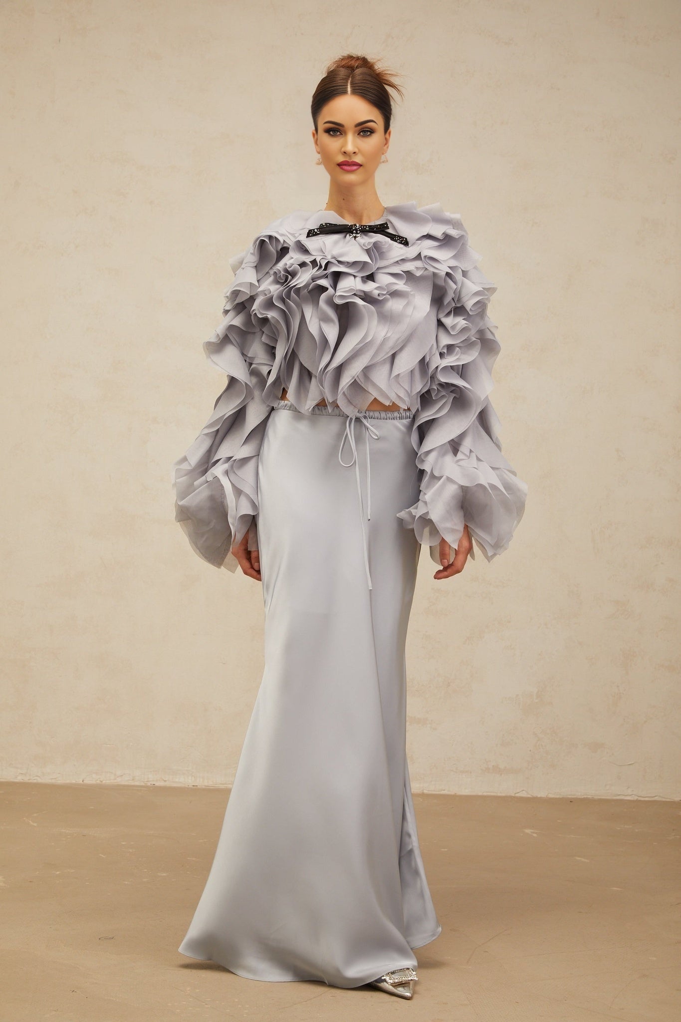 Young girl wearing a light blue matching set with a ruffled blouse and skirt featuring a bow detail in a Zelda inspired design