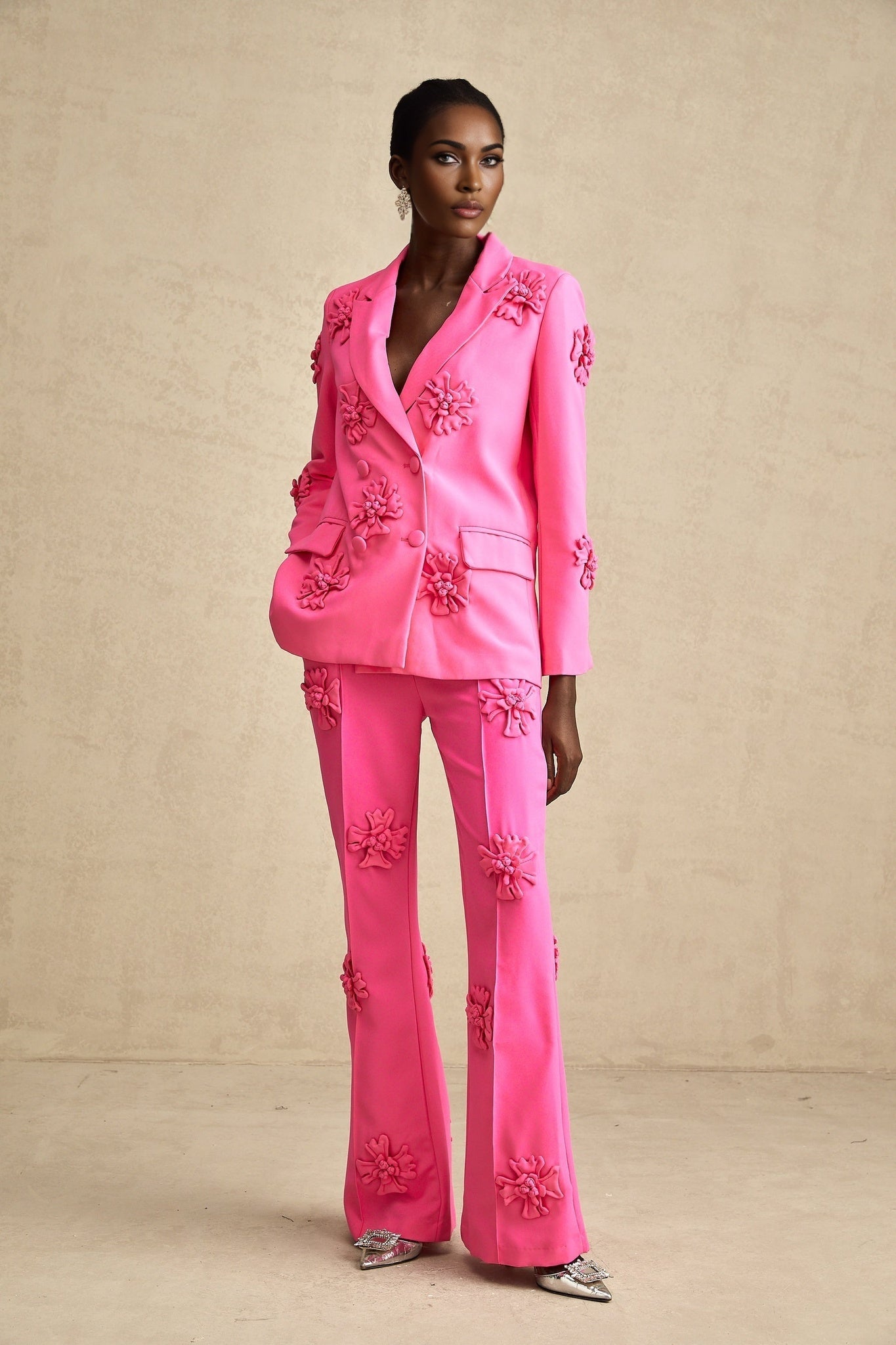 Young girl wearing a pink floral jacket and matching trousers set named AmelieRose