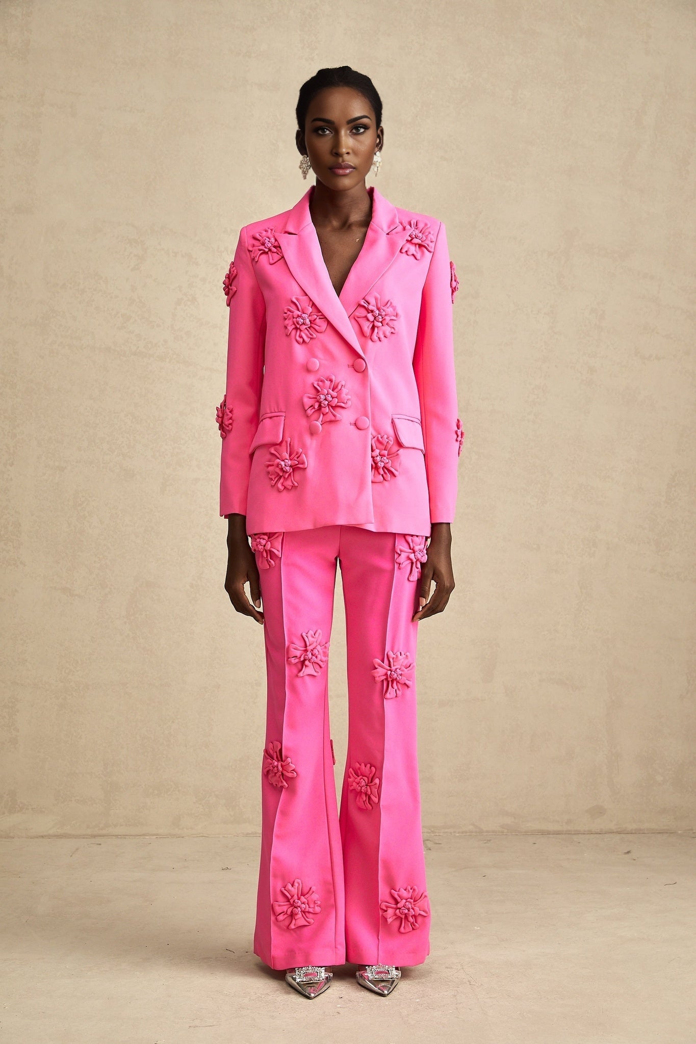 Young girl wearing a pink floral jacket with matching trousers set named AmelieRose