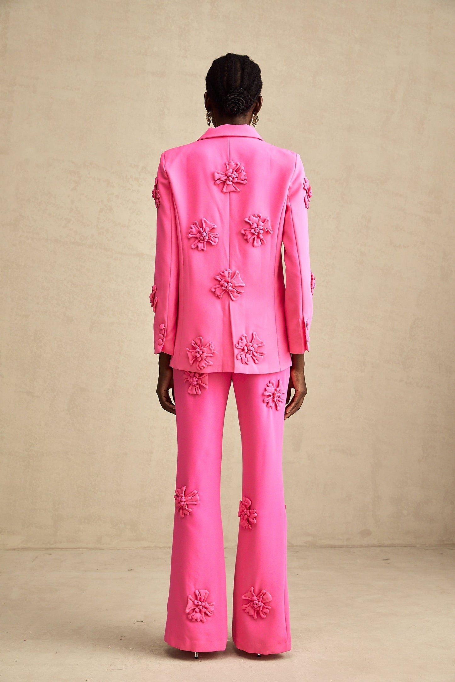 Young girl wearing pink floral jacket and matching trousers set named AmelieRose
