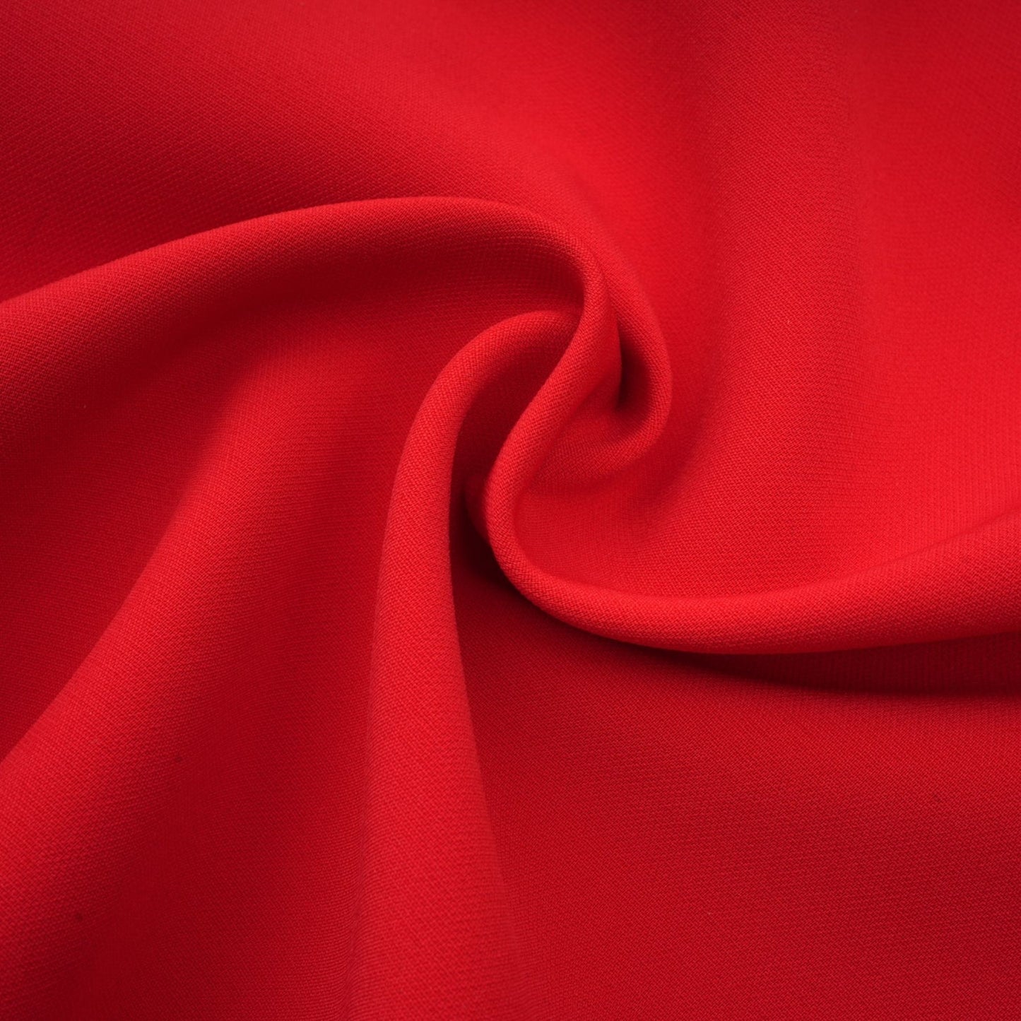 Young woman wearing a short red dress with petal sleeves and a bow detail featuring a cutout design