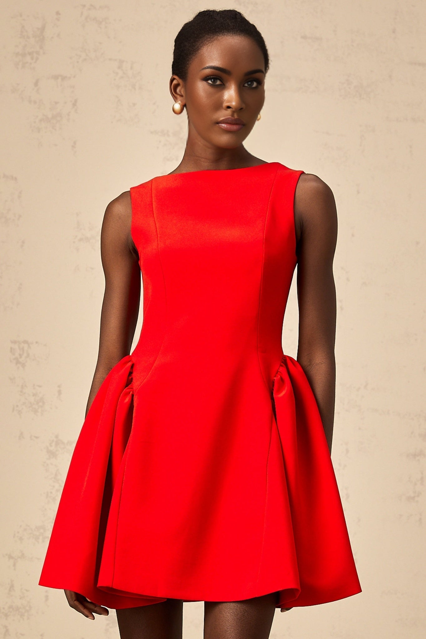 Young woman wearing a vibrant red sleeveless mini dress with a flared skirt