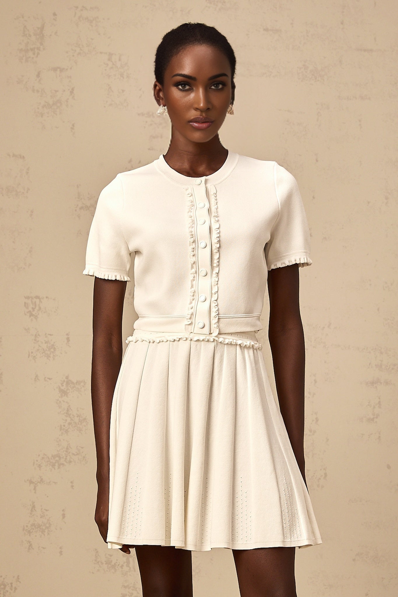 Zelda matching set featuring a white knit top with ruffled trim and a coordinating white skirt