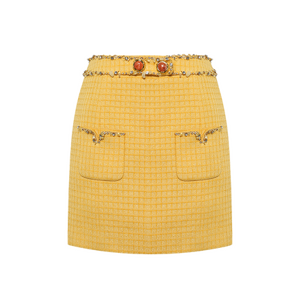 Sophia embellished tweed mini skirt in vibrant yellow with a high-waisted fit, crystal embellishments, gemstone belt, and front pocket details, crafted from 100% polyester.