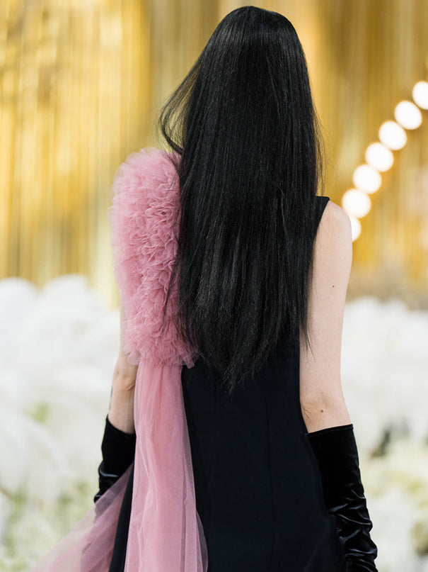 Sophia black dress with a classic A-line silhouette, gold button details, and dramatic pink tulle embellishment, crafted from polyester and nylon.