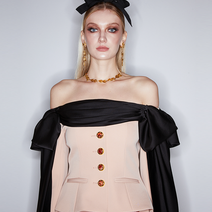 Corset-style top with off-shoulder draped detailing, decorative buttons, and tailored fit. Made from 90% polyester, 10% spandex, and lined with 100% polyester