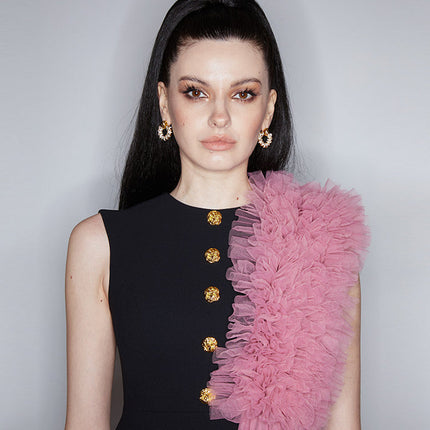 Sophia black dress with a classic A-line silhouette, gold button details, and dramatic pink tulle embellishment, crafted from polyester and nylon.