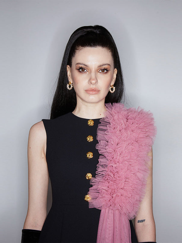 Sophia black dress with a classic A-line silhouette, gold button details, and dramatic pink tulle embellishment, crafted from polyester and nylon.