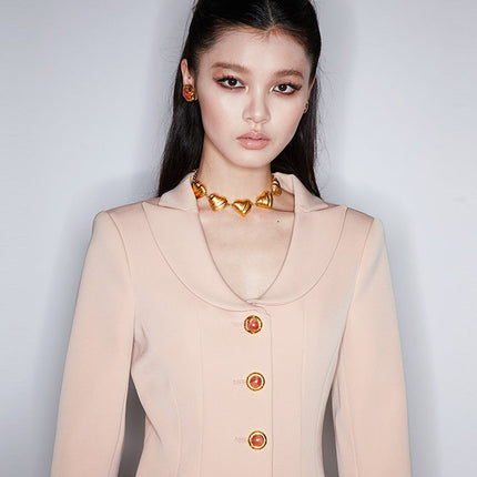 Fitted blazer dress with decorative buttons, tailored silhouette, and flap pockets. Made from 90% polyester, 10% spandex, and lined with 100% polyester