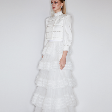 Sophia lace-embellished blouse with a high neckline, intricate lace detailing, puffed sleeves, and tailored fit, crafted from cotton, nylon, and spandex.