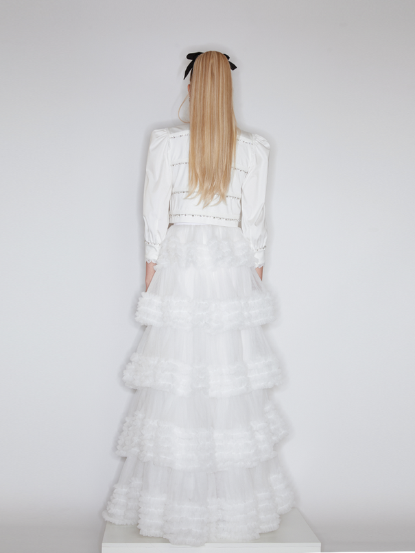 Sophia lace-embellished blouse with a high neckline, intricate lace detailing, puffed sleeves, and tailored fit, crafted from cotton, nylon, and spandex.