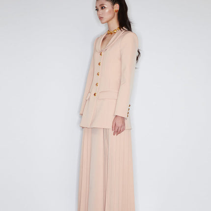 Fitted blazer dress with decorative buttons, tailored silhouette, and flap pockets. Made from 90% polyester, 10% spandex, and lined with 100% polyester