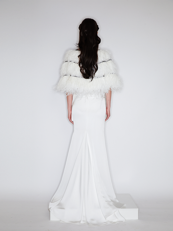 Sophia feather-embellished cape with tiered ostrich feathers, black trim accents, and a relaxed fit, crafted from lightweight polyester.