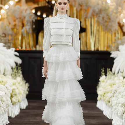 Sophia lace-embellished blouse with a high neckline, intricate lace detailing, puffed sleeves, and tailored fit, crafted from cotton, nylon, and spandex.