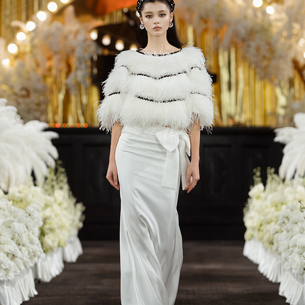 Sophia asymmetric white evening dress with a delicate bow detail, flowing silhouette, and layered hemline, crafted from lightweight polyester.